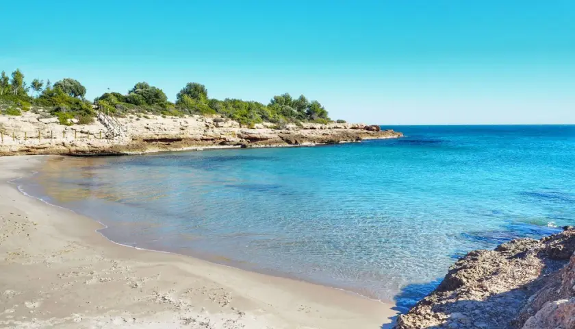 La cala vidre, con su arena dorada y aguas cristalinas, invita a un baño refrescante bajo el sol.