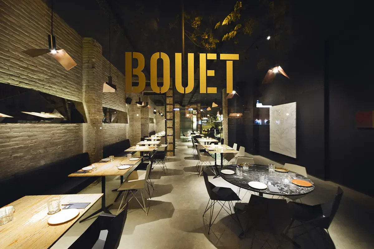 El interior moderno de **el bouet valencia**, con mesas listas para cenar y un ambiente elegante.