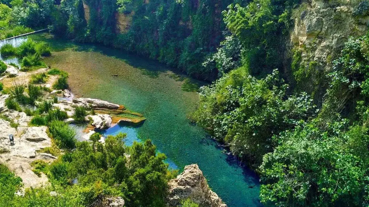 El lago de Anna, un oasis de aguas cristalinas rodeado de exuberante vegetación y rocas.
