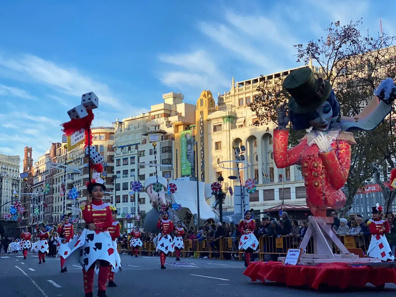 Desfile de la cabalgata del ninot con trajes de cartas y un gran ninot de payaso.