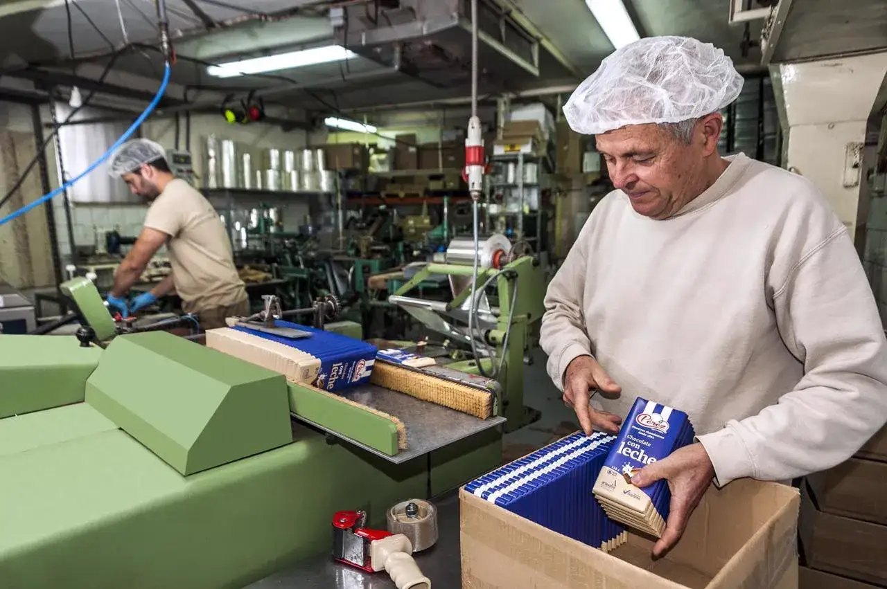 Obrero empaqueta chocolates Pérez Villajoyosa en una fábrica.