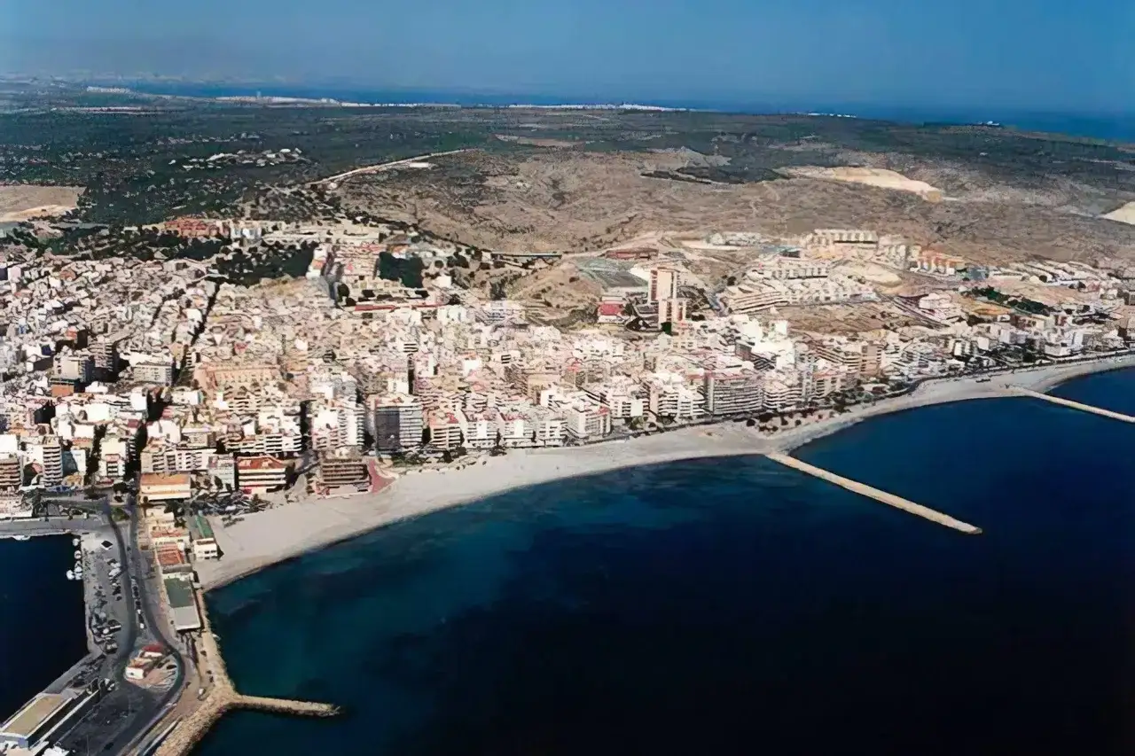 Vista aérea de la playa Levante Santa Pola, con edificios blancos y el mar azul.