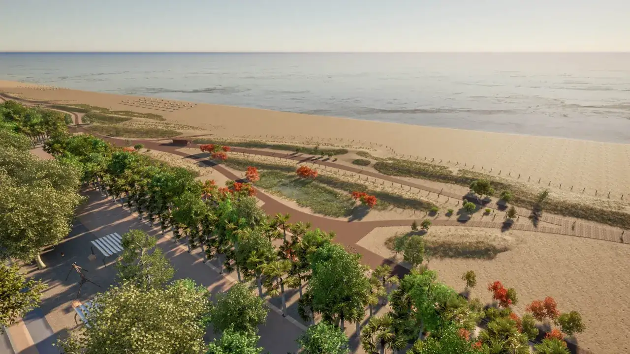 Un paseo marítimo ajardinado en la playa Malvarrosa, con senderos de madera, vegetación y el mar al fondo.